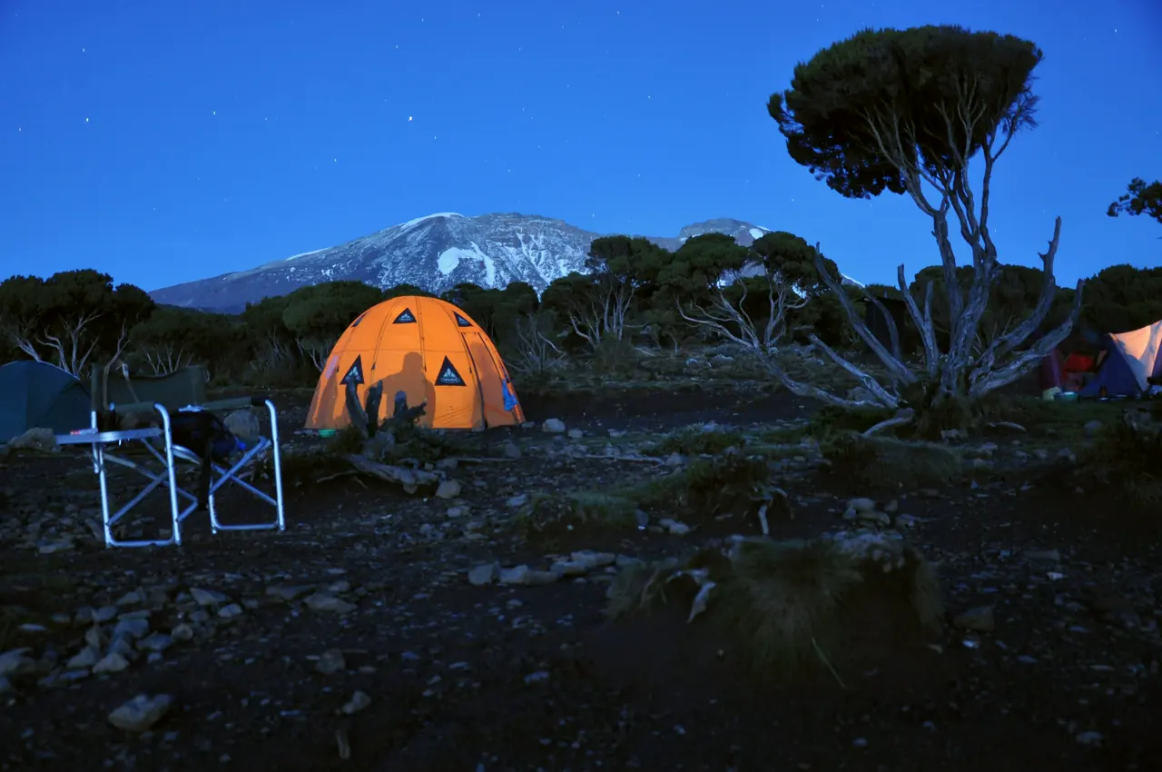 A tent on Kilimanjaro with the summit behind